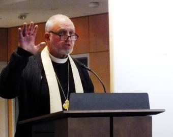 Father Gordon Blue of the Holy Trinity Episcopal Church delivers a benediction at Father Andrew P. Kashevaroff State Library, Archives and Museum.