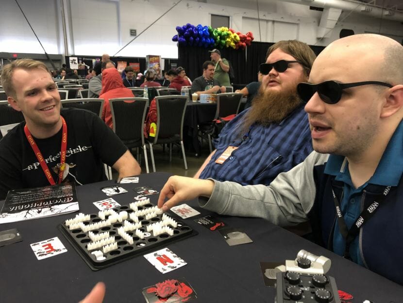 (From left) Judson Rusk, Calvin Drank and Seaton Bryan play Nyctophobia, a board game where players are unable to see the board. The three traveled to SHUX earlier this fall to try new board games and meet the creators of some of their favorites.