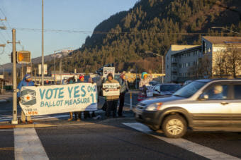 Ballot Measure 1 supporters greet early morning commuters on Election Day, Tuesday, November 6, 2018, in Juneau, Alaska.