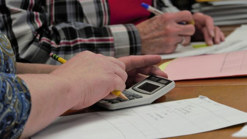 State Review Board members Lynda Thater-Flemmer and Stuart Sliter tally up ballots cast in the House District 1 election at the Juneau office of the Alaska Division of Elections on Nov. 23, 2018.