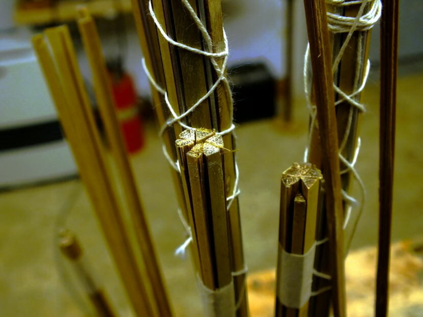 Rough cut batches of three-sided bamboo strips wait for more planing and gluing.