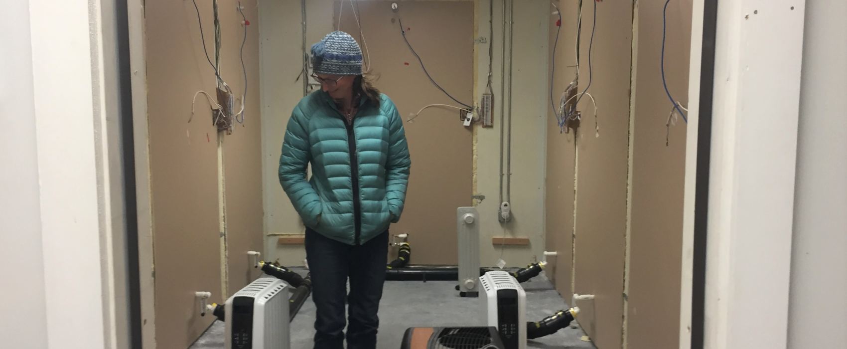 Research engineer Robbin Garber-Slaght in the Cold Climate Housing Research Center's mobile test lab. They're doing an experiment that they hope will lead to cheaper insulation retrofits that have low risk of mold. (Ravenna Koenig/ Alaska's Energy Desk).