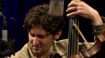 Video still of Ryan Bowers playing bass at KTOO during the 2018 Alaska Folk Festival. He's performing with the Fairbanks band Ryan Bowers and the Brain Trust for a Red Carpet Concert.