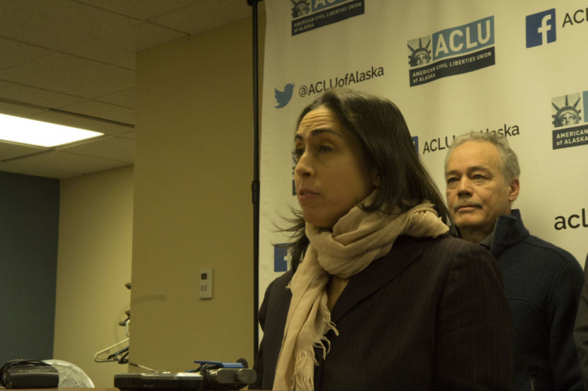Former Assistant Attorney General Libby Bakalar speaking at a press conference on Thursday. Bakalar is one of three plaintiffs in lawsuits filed by the ACLU of Alaska against the Dunleavy administration, claiming that she was illegally terminated by the governor. Former Alaska Psychiatric Institute Staff Psychiatrist Dr. John Belville (right) is another plaintiff. (Photo by Wesley Early, Alaska Public Media)