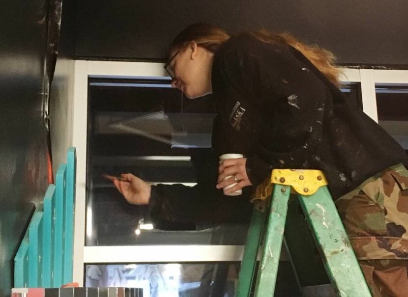 Jenn Tucker paints inside the Tongass Historical Museum, one of the part-time jobs she was offered to help her family get through the partial federal shutdown.
