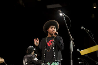 Juneau-Douglas High School: Yadaa.at Kalé senior Arias Hoyle raps as the opening artist for Khu.éex' at Centennial Hall on Monday, January 28, 2019. The Juneau MC has released two videos for his song "Zibit" and "Ix̱six̱án, Ax̱ Ḵwáan (I Love You My People)" sponsored by Tlingit and Haida’s Tribal Family and Youth Services department's Native Connections program. (Photo by Annie Bartholomew/KTOO)