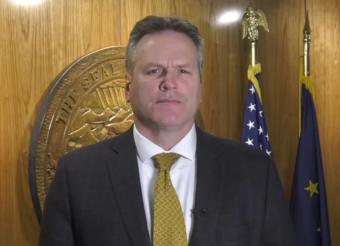 Gov. Michael Dunleavy prepares to speak about offering Alaska National Guard support for President Donald Trump's national emergency declaration, Feb. 15, 2019.