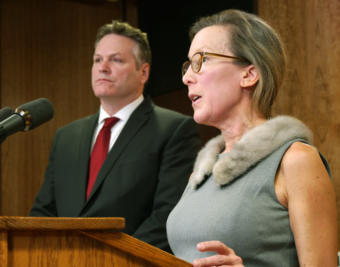 Office of Management and Budget Director Donna Arduin helps Gov. Michael Duleavy explain various aspects of his proposed state budget at a press availability in the Capitol in Juneau on Feb.13, 2019.