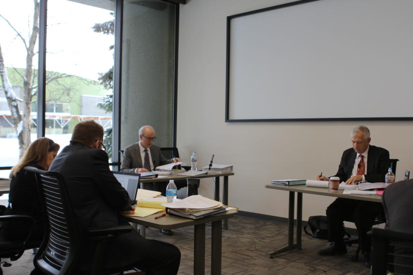Hollis French, center, testifies at a Feb. 8, 2019 hearing regarding whether he should be fired from his post at AOGCC for cause.