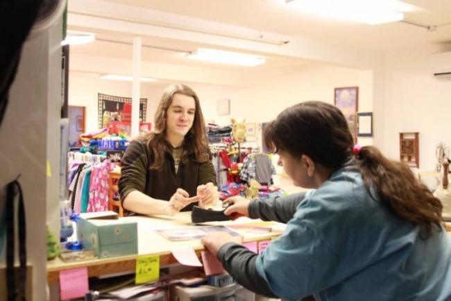 Pacific High senior Killian DeTemple, left, posted flyers around Sitka alongside other teens working to establish a Teen Center in Sitka. (Photo by Enrique Pérez de la Rosa/KCAW)