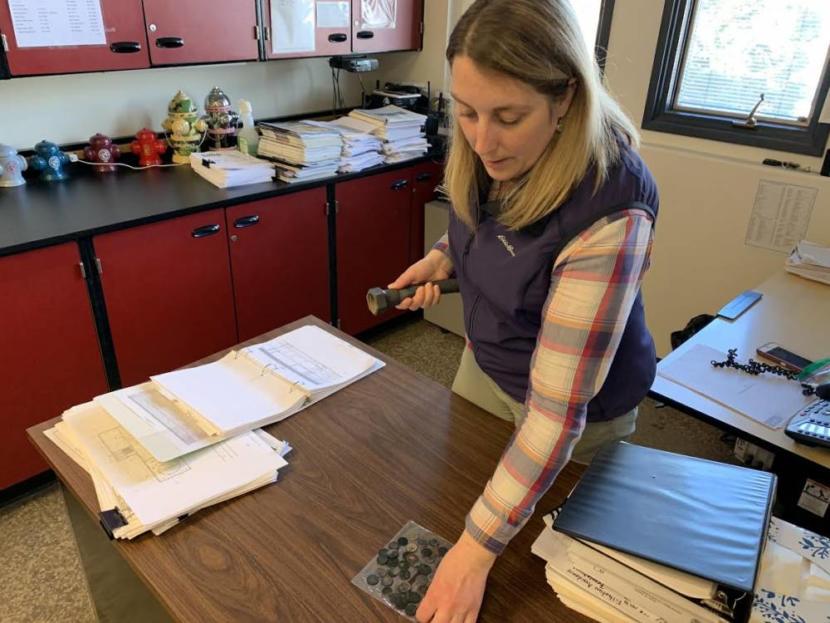 Environmental Superintendent Shilo Williams displays a handful of coins that are corroding, exposed to the hydrogen sulfide gas that permeates the facility.