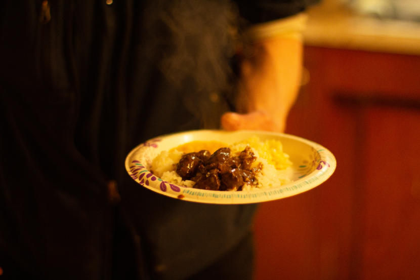 Robert Melovidov holds a plate of fur seal and rice.