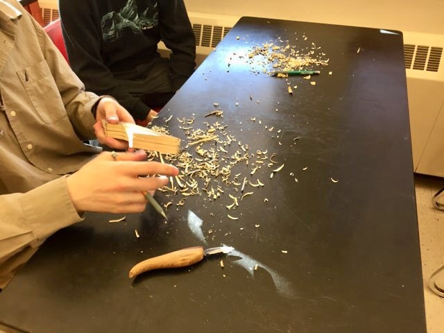 Students at Juneau-Douglas High School: Yadaa.at Kalé begin carving Tlingit halibut hooks on March 5, 2019. (Photo by Zoe Grueskin/KTOO)