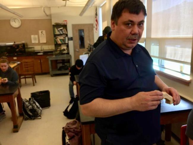 Tlingit carver Donald Héendei Gregory teaches students at Juneau-Douglas High School: Yadaa.at Kalé how to carve Tlingit halibut hooks on March 5, 2019. (Photo by Zoe Grueskin/KTOO)
