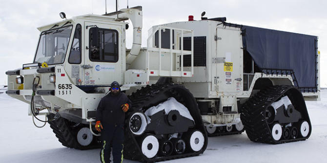 A worker stands in front of a vibe truck being used as part of BP’s 3-D seismic program at Prudhoe Bay this winter.