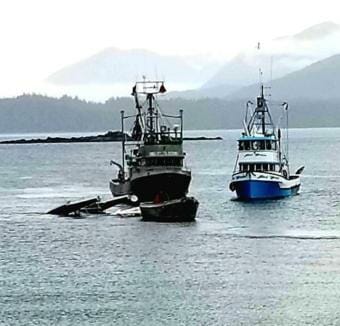 A Taquan Beaver is towed to shore after crashing into the water near Metlakatla, May 20, 2019. Both people on board were killed.