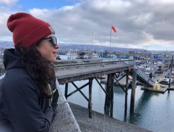 Alex Ravelo, a former NOAA Fisheries observer, looks out onto Homer's docks.