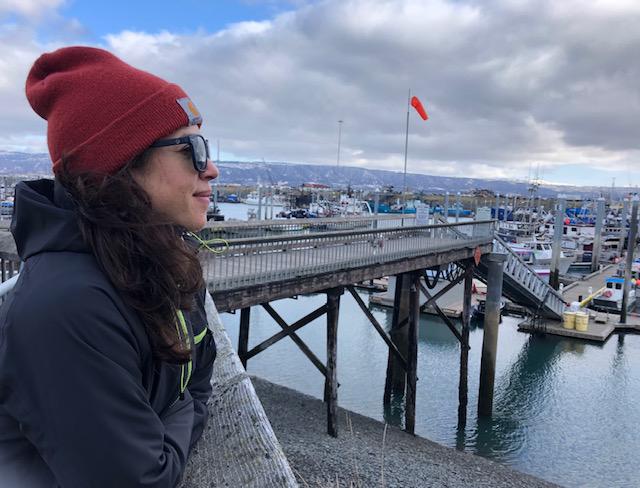 Alex Ravelo, a former NOAA Fisheries observer, looks out onto Homer's docks.