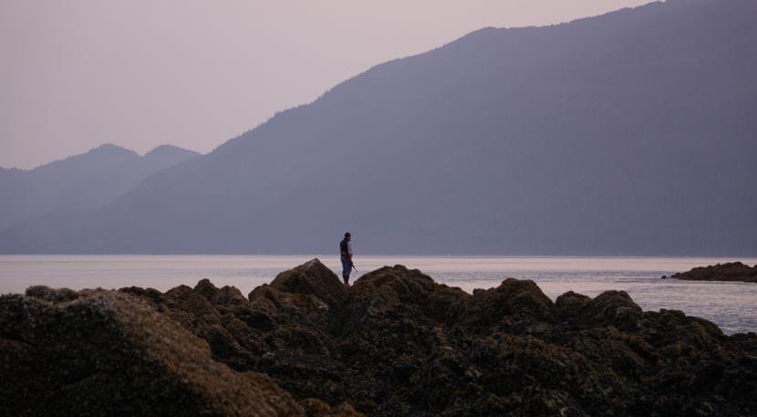 Lyle James scans the waters of Lynn Canal for harbor seals during a hunt early on the morning of June 30, 2019.
