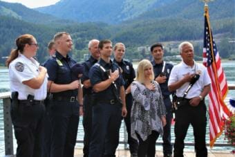 Ashley DeRamus recites the Pledge of Allegiance with members of Capital City Fire/Rescue. (Photo by Adelyn Baxter/KTOO)