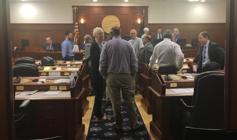 State representatives and senators mill around the Alaska House floor during a break in a joint session on Thursday. (Photo by Andrew Kitchenman/KTOO and Alaska Public Media)