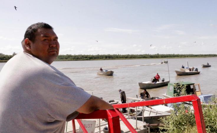 Commerical fisherman and Kwik'Pak store clerk Kenneth Lee gassing up boats in Emmonak, Alaska on July 15, 2019. (Photo by Anna Rose MacArthur/KYUK)