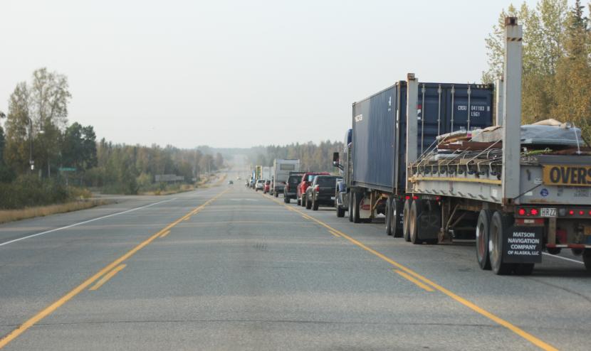 A line of traffic waits for a pilot car to lead drivers through the stretch of the Parks Highway north of Anchorage, where the McKinley Fire is still burning on Tuesday, Aug. 20, 2019.