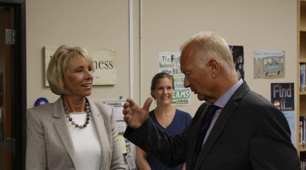 U.S. Education Secretary Betsy DeVos speaks with Mat-Su Central School principal John Brown. Brown toured DeVos around the school on Aug. 26, 2019. (Photo by Wesley Early, Alaska Public Media – Anchorage)
