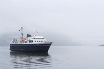 The Aurora, a 235-foot Alaska state ferry, approaches the dock in Whittier, its departure point for its trip across Prince William Sound to Cordova. (Photo by Nat Herz/Alaska's Energy Desk)