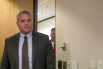 Alaska Gov. Mike Dunleavy follows Deputy Attorney General Treg Taylor into a news conference at the governor's Anchorage office on Friday, Sept. 27, 2019.