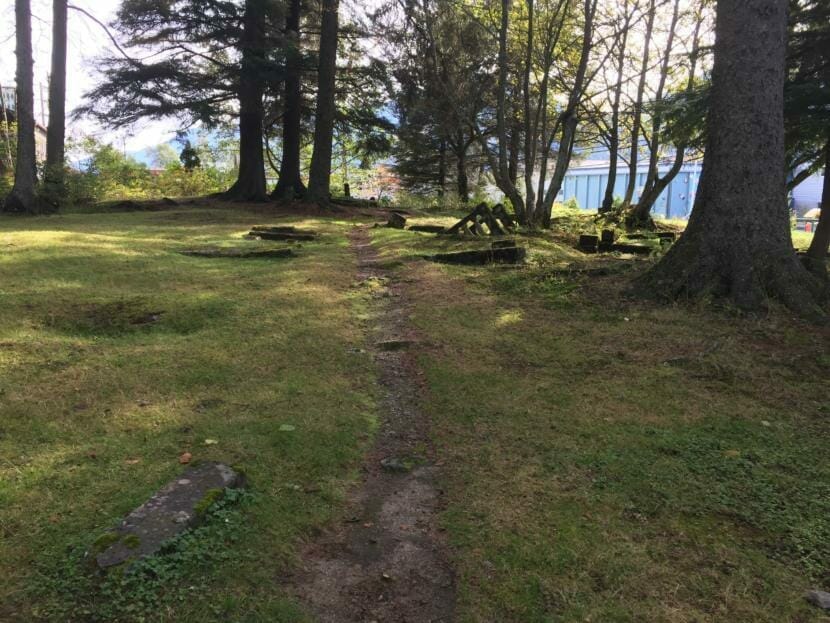 Toppled and overgrown headstones in Juneau's Evergreen Cemetery, pictured on Sep. 28, 2019. (Photo by Zoe Grueskin/KTOO)