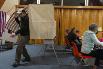 A voter leaves the booth as election workers at Northern Light United Church assist other voters during Municipal Elections on October 1, 2019, in Juneau, Alaska. (Photo by Rashah McChesney/KTOO)