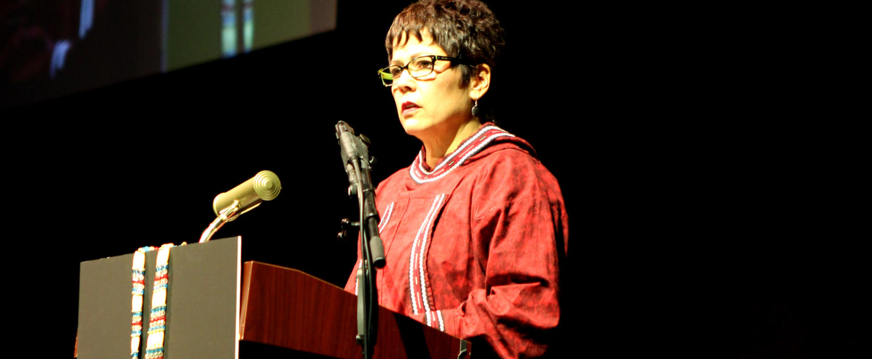 Cook Inlet Region, Inc. President and CEO Sophie Minich speaks about why the Alaska Native corporation supports the recall of Gov. Mike Dunleavy at the Alaska Federation of Natives Convention in Fairbanks on Oct. 18, 2019. (Photo by Casey Grove/Alaska Public Media)