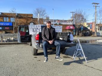 Alex JustAlex sits in the rental truck he uses as a stage for his drive-in stand up comedy show at Chilkoot Charlie’s in Anchorage on April 10, 2020. (Mayowa Aina/Alaska Public Media)