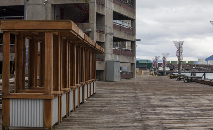 A row of booths used by waterfront vendors during the summer tourist season sit empty on Saturday, March 21, 2020 in Juneau, Alaska. Juneau's Docks and Harbors Board approved a refund fees to use these booths as the COVID-19 pandemic has decimated Alaska's tourism season. (Photo by Rashah McChesney/KTOO)