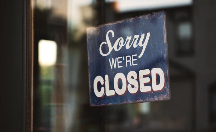 A sign in a window saying "Sorry we're closed."