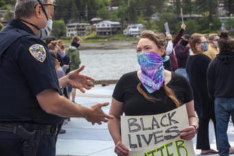 Juneau Police Department Deputy Chief David Campbell and Borough Assembly member Alicia Hughes-Skandijs talk amid a crowd of about 250 people gathered for a public “I Can’t Breathe” rally protesting the death of a black man, George Floyd, who was killed after a white officer pressed a knee into his neck while taking him into custody in Minnesota. People held signs decrying violence against black people and calling out institutional racism, many supporting the Black Lives Matter movement on Saturday, May 30, 2020 in Juneau, Alaska. Similar protests happened throughout the state with hundreds turning out in Fairbanks and Anchorage, they’ve also erupted in dozens of cities all over the country. (Photo by Rashah McChesney/KTOO)