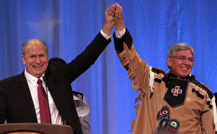 Alaska Gov. Bill Walker and Lt. Gov. Byron Mallott join hands after their inauguration on Dec. 1, 2014, at Centennial Hall in Juneau. 