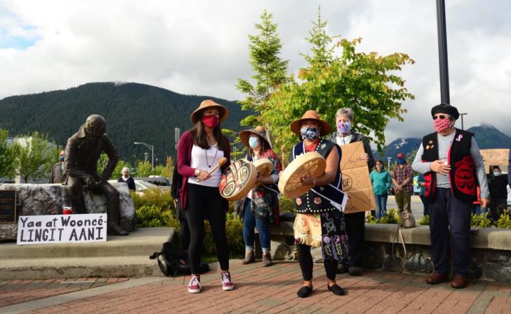 Dionne Brady-Howard, whose Tlingit name is Yeidikoo’aa, drums and leads a song after speaking to the crowd about why she wants the city to relocate the statue of Alexander Baranov: “No, it is not about political correctness. It is about accuracy. The teaching of accurate history is the only thing that keeps us from repeating those mistakes.” (Berett Wilber/KCAW)