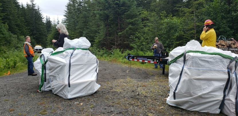 U.S. Forest Service personnel and a visitor wait for weather to clear near the Gastineau Meadows trailhead on Douglas Island after prepping supplies to be airlifted to the Dan Moller Cabin on Friday, July 24, 2020.