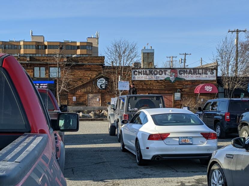Chilkoot Charlie’s is one of the largest bars on the list, though not associated with many cases. The city says two people known to be infected with COVID-19 visited in June. This photo is from a drive-in comedy show held in the parking lot in April. (Mayowa Aina/Alaska Public Media)