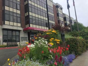 The front entrance to the Anchorage Pioneer Home with flower beds