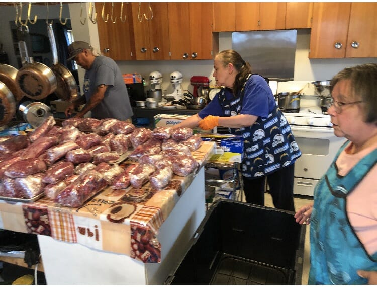 Kake residents and Elders process moose meat to be distributed to the community