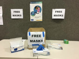 Free face masks, gloves and hand sanitizer was available for voters as a COVID-19-related safety measure during Alaska's primary election on Aug. 18, 2020, at Juneau-Douglas High School Yadaa.at Kalé. (Photo by Andrew Kitchenman/KTOO and Alaska Public Media)