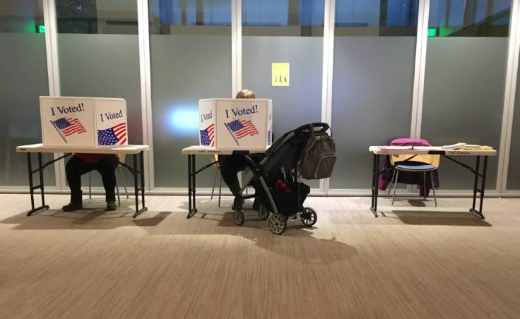 Voters fill out their ballots just an hour before voting was to end in Juneau's municipal elections on Oct. 6, 2020, at Juneau Public Libraries' Valley Branch. Most voters cast their votes by mail, but some went to vote in person. (Photo by Andrew Kitchenman/KTOO and Alaska Public Media)