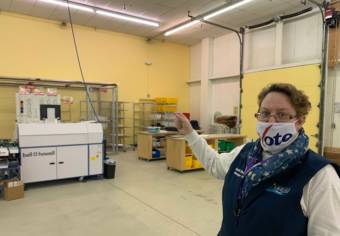 Inside the Anchorage Election Center in October 2020, Juneau City Clerk Beth McEwen gestures to the sorter being used to process ballot envelopes in Juneau's local election. Initial election results are expected at 5 p.m. (Photo by Adelyn Baxter/KTOO)