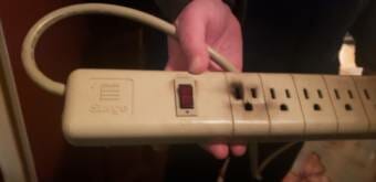 Bev Agler, a resident of Wickersham Avenue in Juneau, shows a surge protector that got fried at her home by the Nov. 11 power surge