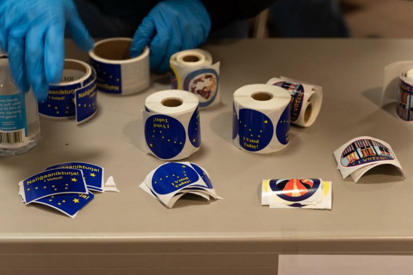 Voting stickers are offered to voters at the Bethel polling site on Election Day. Nov. 3, 2020. (Photo by Katie Basile / KYUK)