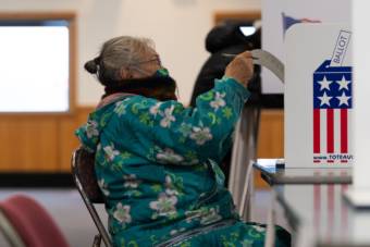 Edna Mathlaw of Bethel reads her ballot on Nov. 3, 2020 in Bethel, Alaska. (Photo by Katie Basile / KYUK)