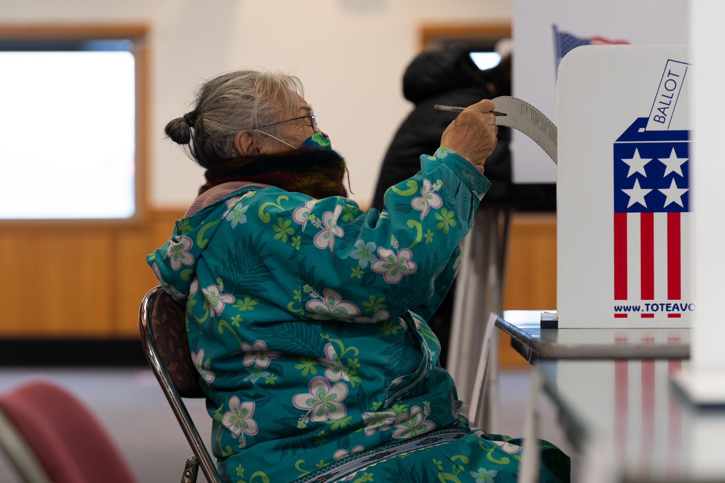 Edna Mathlaw of Bethel reads her ballot on Nov. 3, 2020 in Bethel, Alaska. (Photo by Katie Basile / KYUK)